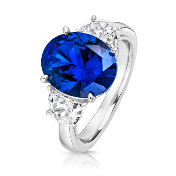 Sterling Silver Blue Oval Centre Stone Claw Set With Half Moon Sides Trilogy Ring